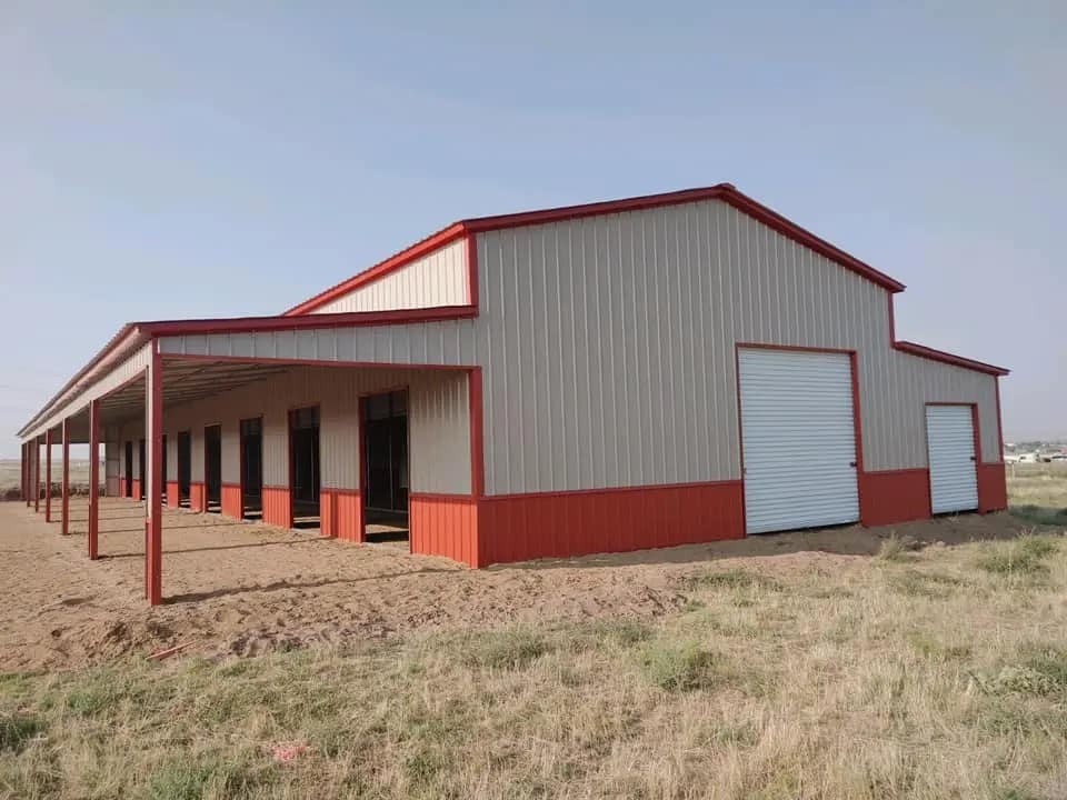 Metal horse barn with red trim by Silverline Structures, showcasing durable design and spacious layout